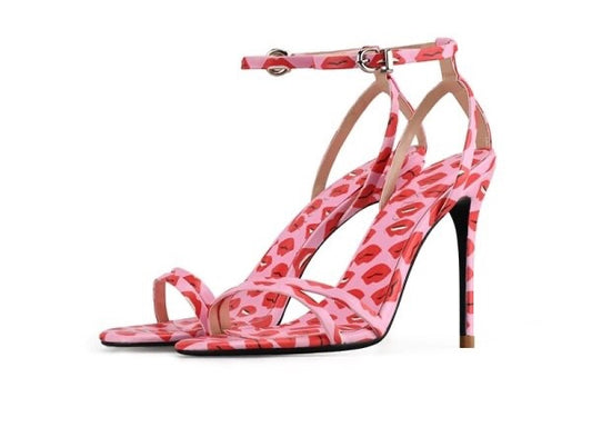 Pink high heeled strappy sandals with lip print