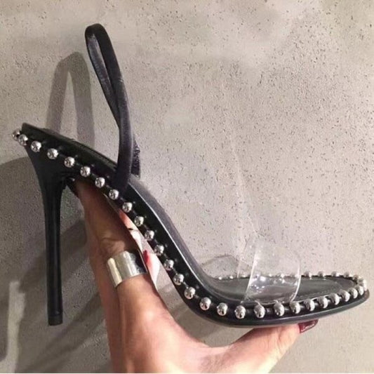 Black heeled sandals with silver balls and perspex strap